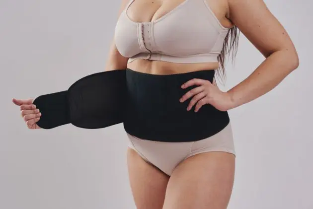 BodyAid black abdominal binder with self-adjusting velcro closure. Hernia and abdominal support.