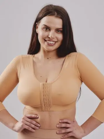 BodyAid arm lift compression crop in beige with 3/4 sleeves & posture support. Front three row hook and eye adjustment. Ideal for Brachioplasty and Liposuction to the arms.