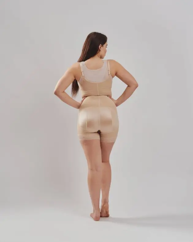BodyAid boy leg bodysuit in beige with front zip. Open crotch and non compressive butt lift shape support Rear view. Leonisa posture bra back support in beige.