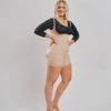 BodyAid boyleg bodysuit in beige with front zipper. Open crotch and non compressive butt lift shape support. BodyAid arm compress crop in black with 3/4 sleeves and posture support.