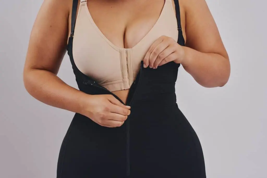BodyAid Stage 1 Capri bodysuit shapewear in black with front zip teamed with beige BodyAid Stage 1 Front fastening post surgery Bra.