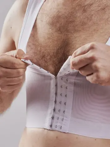 BodyAid chest compression binder in white. Features adjustable front hook and eye closure.