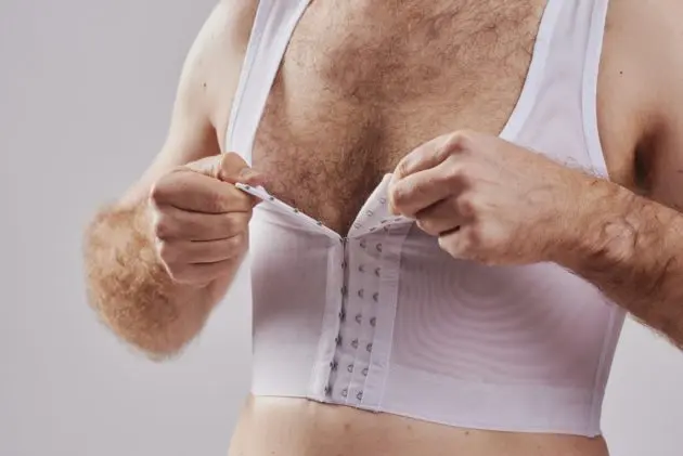BodyAid chest compression binder in white. Features adjustable front hook and eye closure.