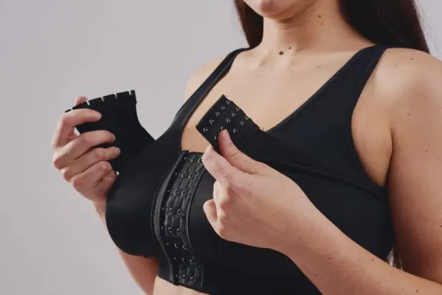 BodyAid stabilizer bra in beige. Adjustable front hook & eye closure. One cup fits all. Removable adjustable stabilizer band for implant placement post surgery.