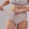 Leonisa Post Partum Panty. Criss-cross band, beige posture corrector bra. Postpartum girdle comfortably slims your low-to-mid tummy compression in beige. Adjustable velcro find your perfect fit, choose your compression level.