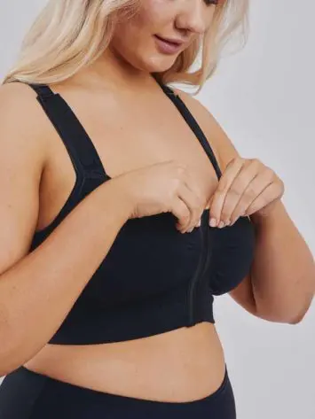 BodyAid black soft front fastening comfortable post op bra. Features adjustable straps and front hook and eye closure.