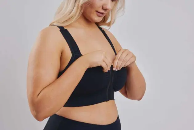 BodyAid black soft front fastening comfortable post op bra. Features adjustable straps and front hook and eye closure.